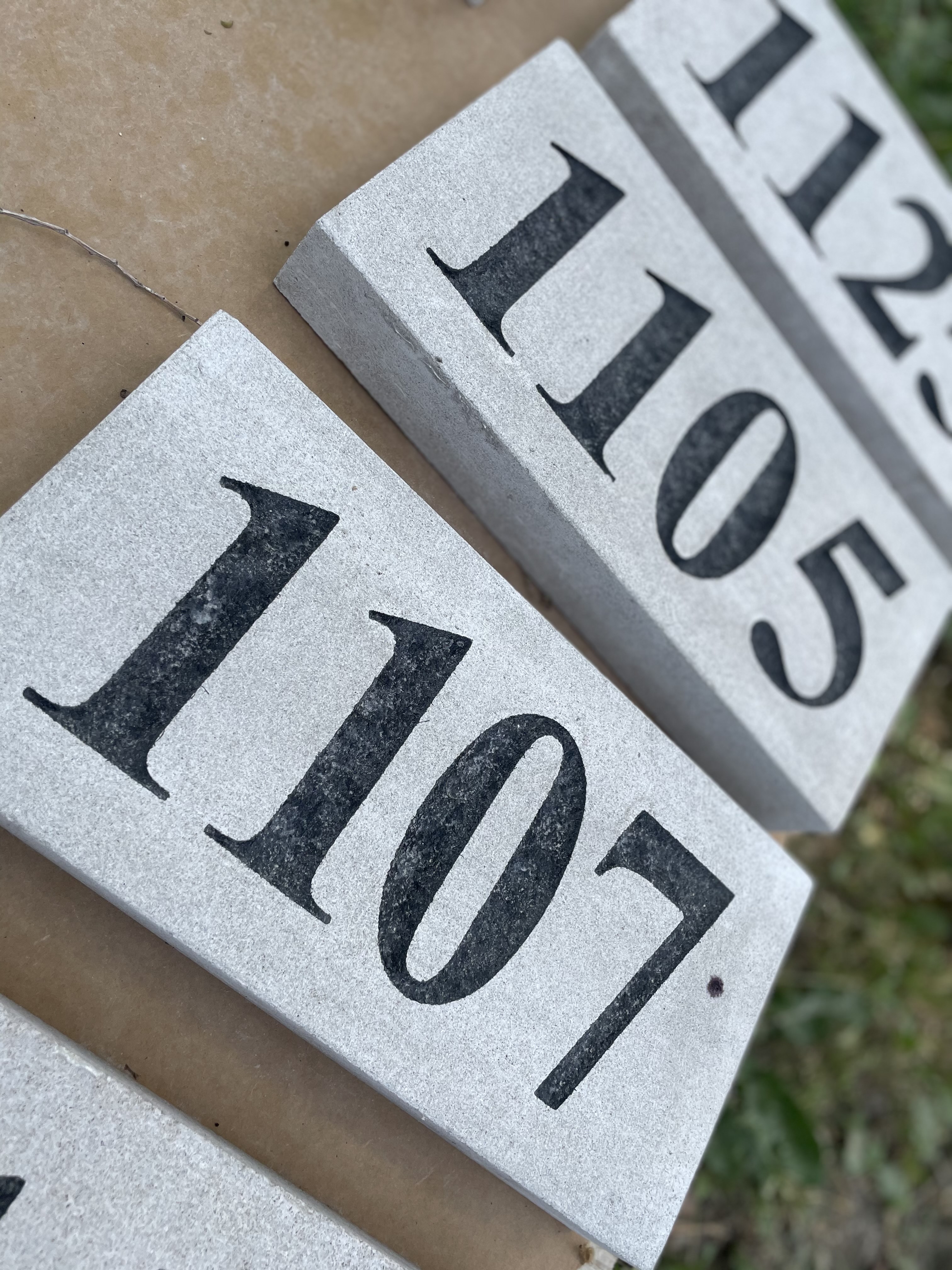 A series of sandblasted limestone address stones